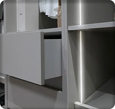 Fitted dressing room detail with a soft-close drawer and lit open shelving