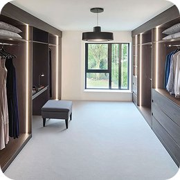 Walk-in fitted dressing room with hanging space either side of a window