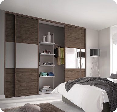 Made to measure walnut fitted wardrobe built around a bed with open shelving